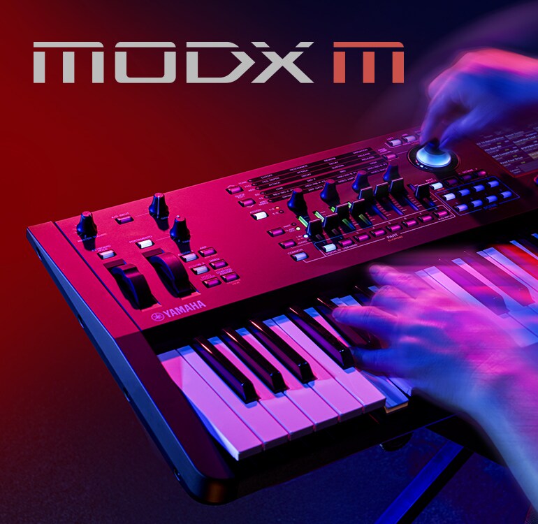 Artistic visual focusing on hands playing a synthesizer in a performance scene