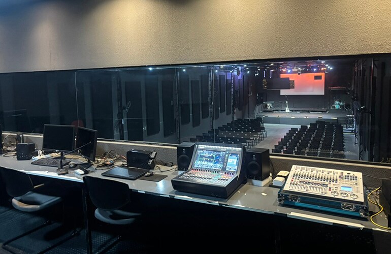 São Paulo training facility control room with digital mixing consoles, displays, and audio equipment racks.