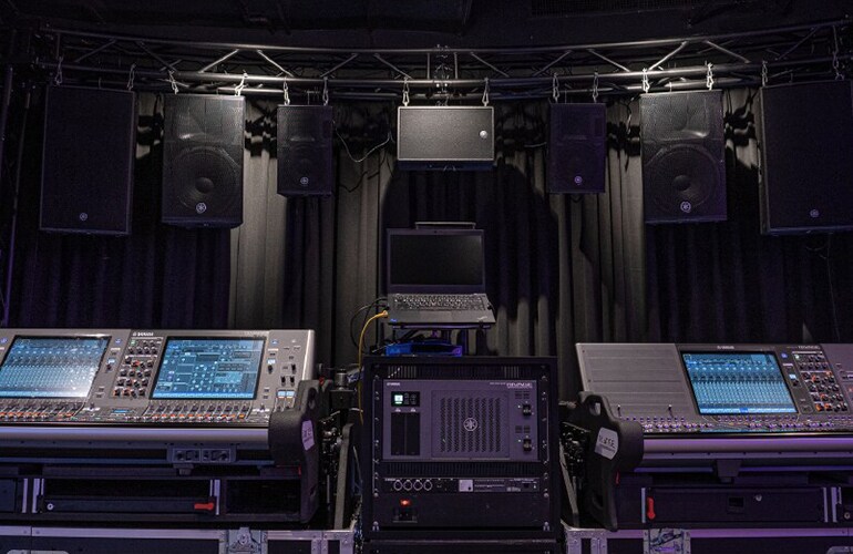 Bangkok training facility with digital mixing consoles and loudspeaker demonstration setup.