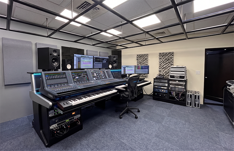 New Taipei City training facility with digital mixing console, loudspeakers, and presentation display.
