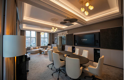 London training facility meeting room with tables, seating, and display screen.