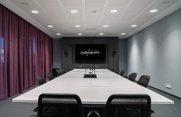 Rellingen training facility with tables, chairs, and presentation display.