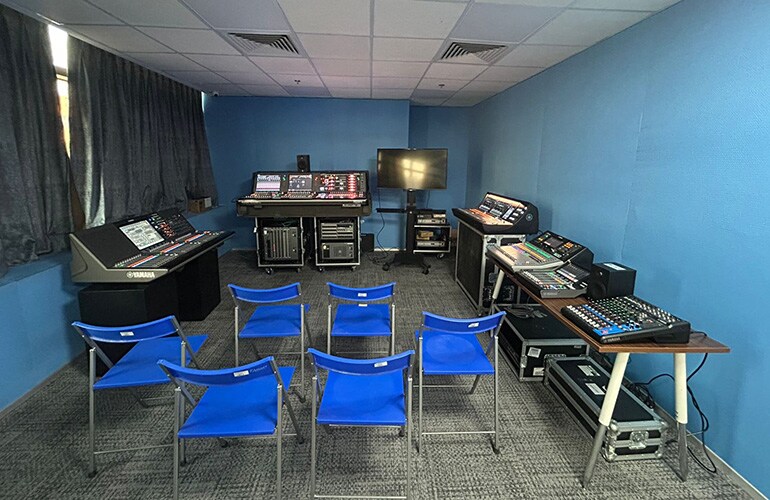 Gurugram training facility with classroom seating, presentation display, and audio training equipment.