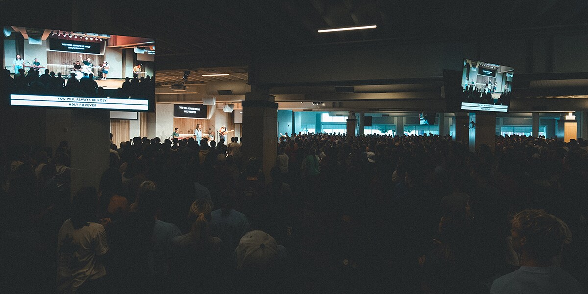 Interior view of CityLight Church worship space in Lincoln, Nebraska with stage lighting and audience seating.